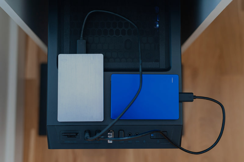 Two external drives cabled to a desktop computer, seen from above.